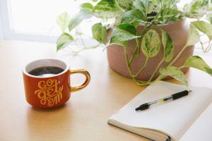 Coffee plant and journal open ready for story to be written