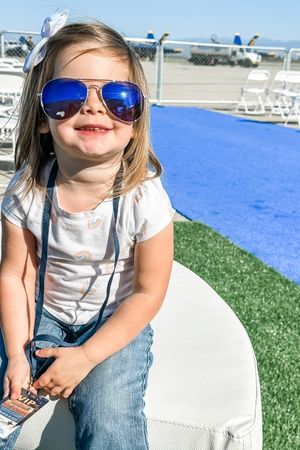 toddler girl in aviators waiting for air show to begin
