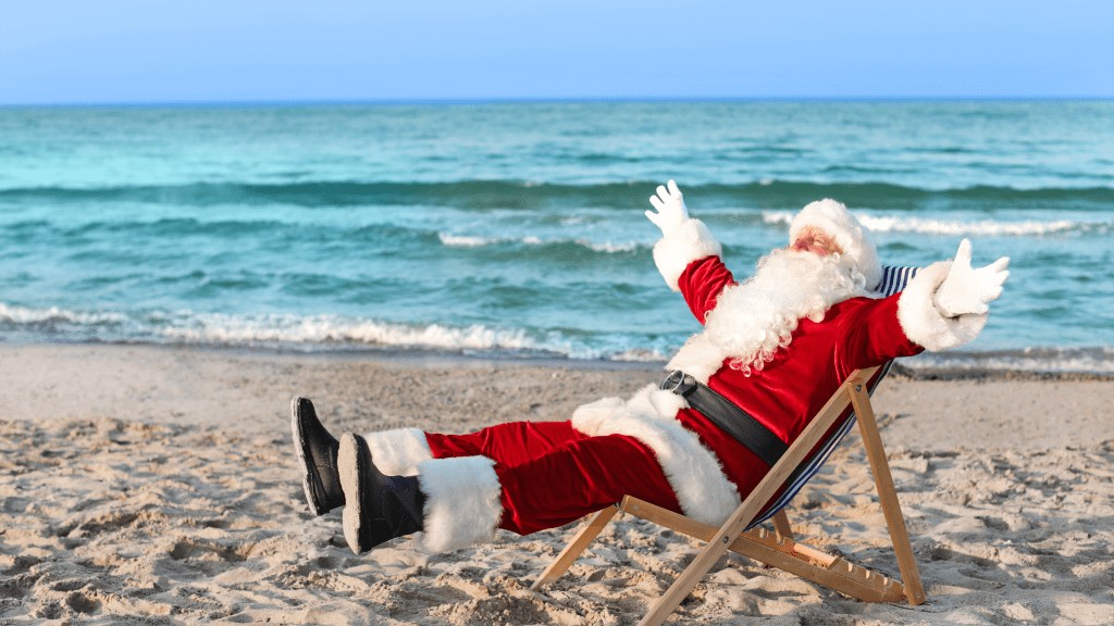 Santa sitting on beach for all the fun christmas things to do in Pensacola